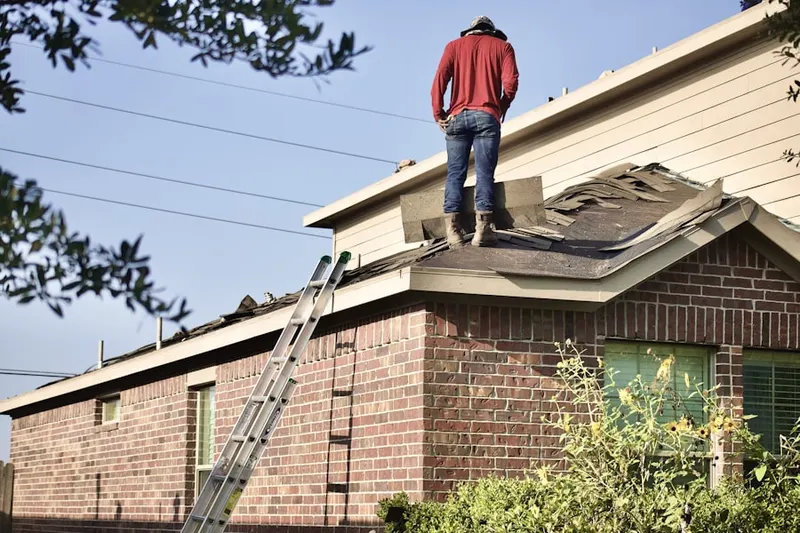 Professional roofer working on a residential roof in Keeter
